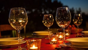 A table set for a meal with wine glasses and candles. - Borgo Saint George (Otricoli)