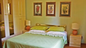 A bedroom with a bed, nightstands, a dresser, and three framed botanical prints on the wall. - Stunning private villa for 8 guests with WIFI, private pool, TV, terrace, pets allowed and parking (Corchiano)
