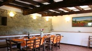 A rustic dining area with a stone wall, wooden beams, and a tiled floor. - Stunning private villa with private pool, WIFI, TV, pets allowed and parking, close to Cortona (Cortona)