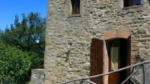 A stone building with a wooden staircase leading to a door. - Stunning private villa with private pool, WIFI, TV, pets allowed and parking, close to Cortona (Cortona)