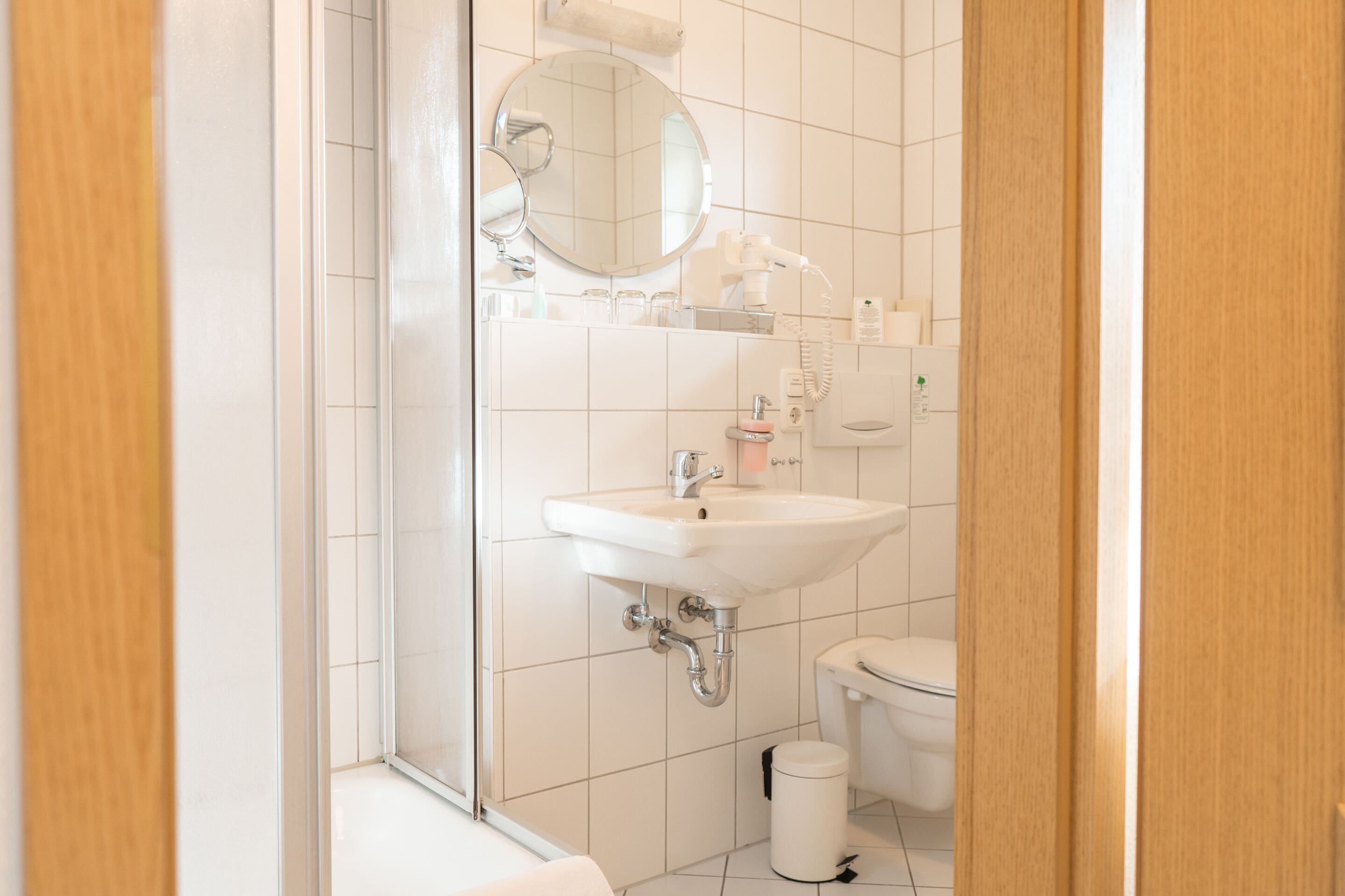 A bathroom with a sink, mirror, and toilet.