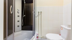 A bathroom with a glass-enclosed shower, a white bathtub, and a toilet. - Guest House on Bessarabska Square (Kyiv)