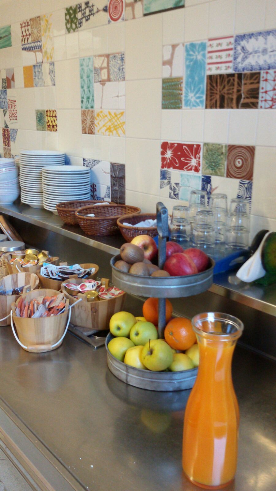 A buffet setup with various food items and utensils.