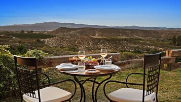 Une table dressée pour un repas, avec une vue sur un paysage montagneux.