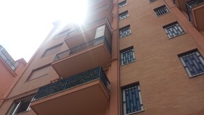 A multi-story building with balconies and windows.