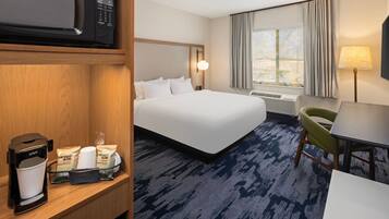 Premium bedding, desk, laptop workspace, blackout drapes