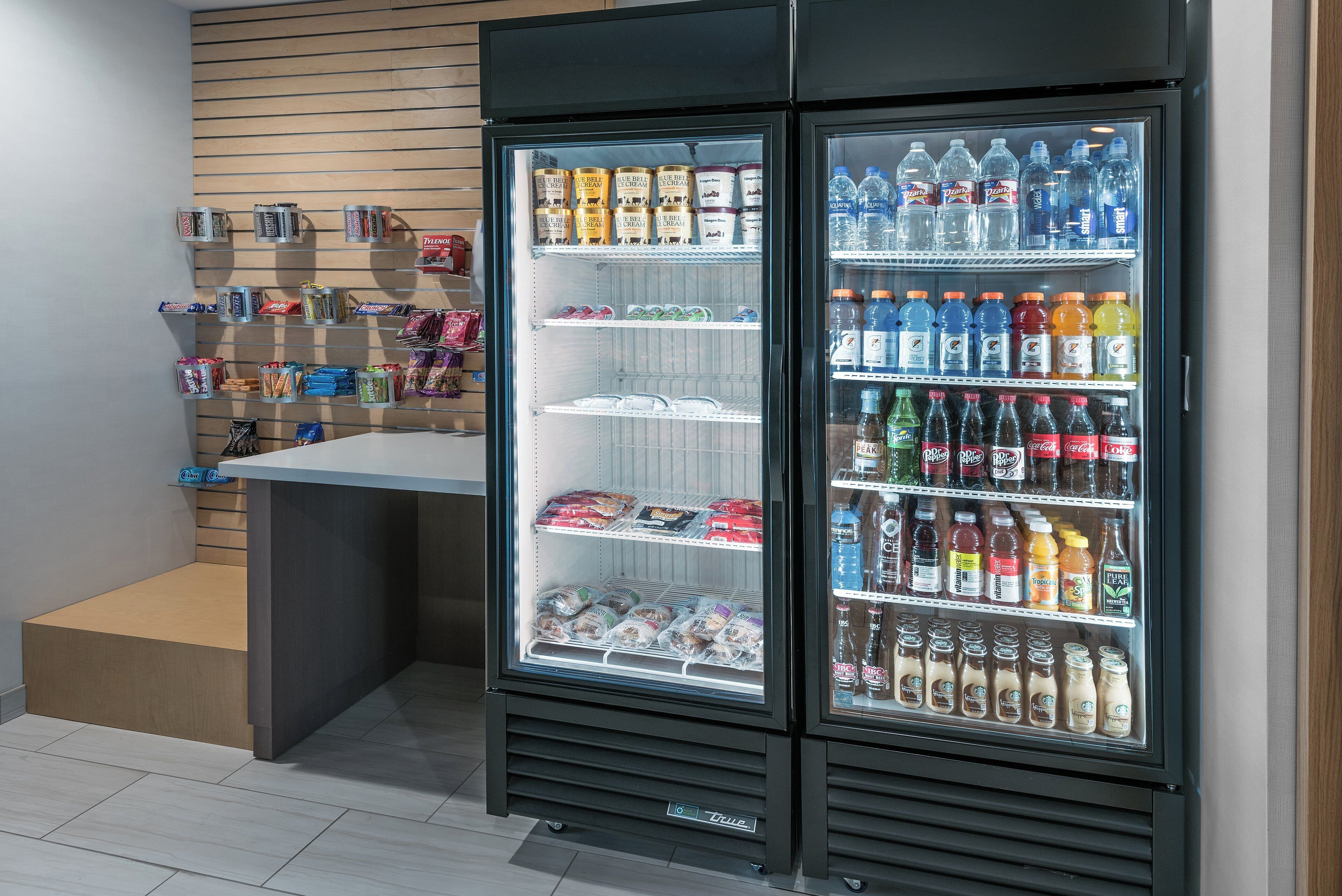 A refrigerated display case with various beverages and snacks.
