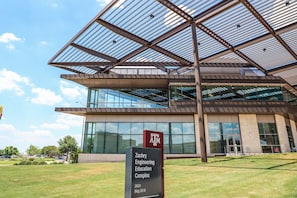 The exterior of the Zachry Engineering Education Complex with a modern design, large glass windows, and a clear sky. - Holiday Inn Express & Suites Bryan - College Station by IHG (Bryan)