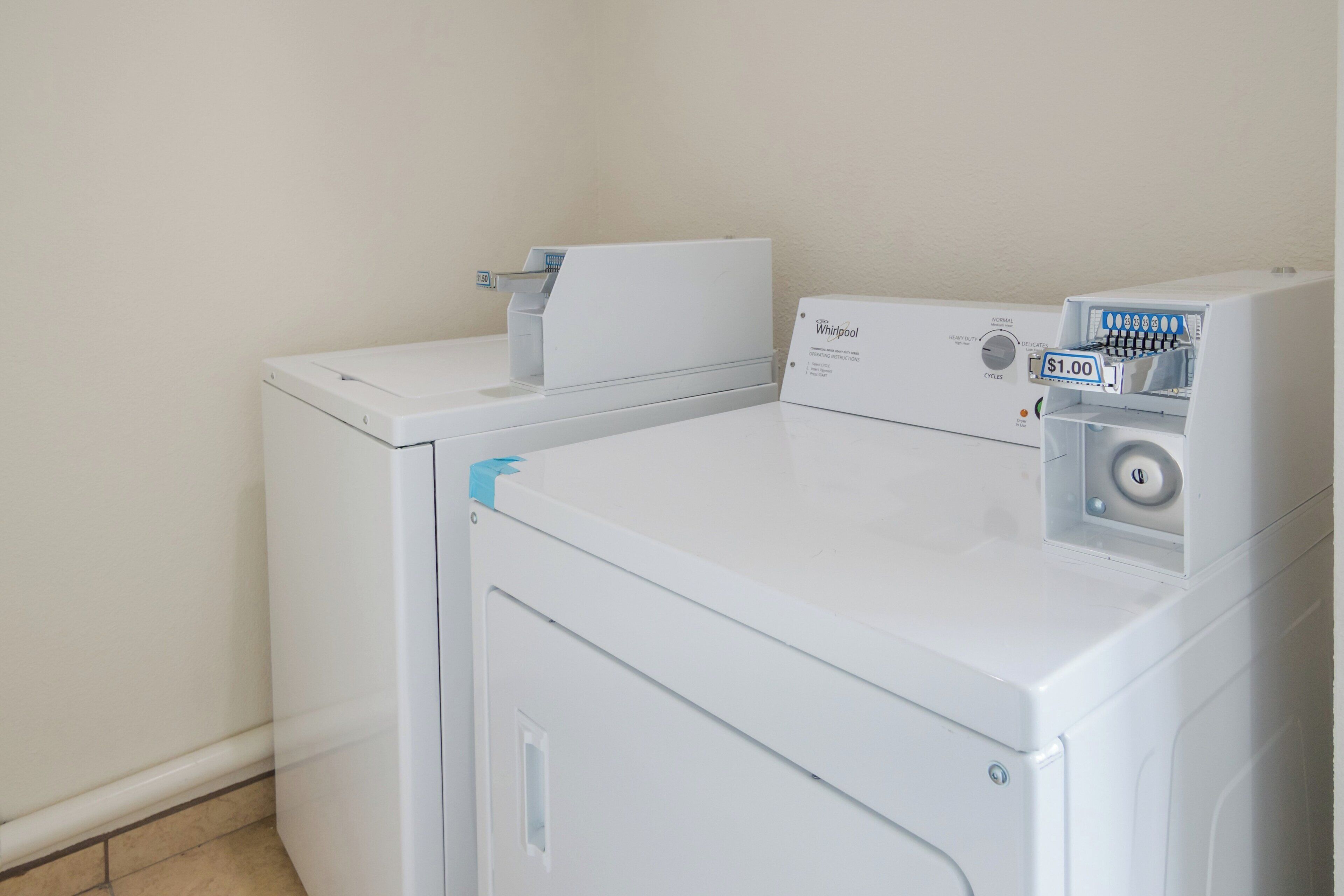 A front-loading Whirlpool washer and dryer unit with a control panel and a price tag.