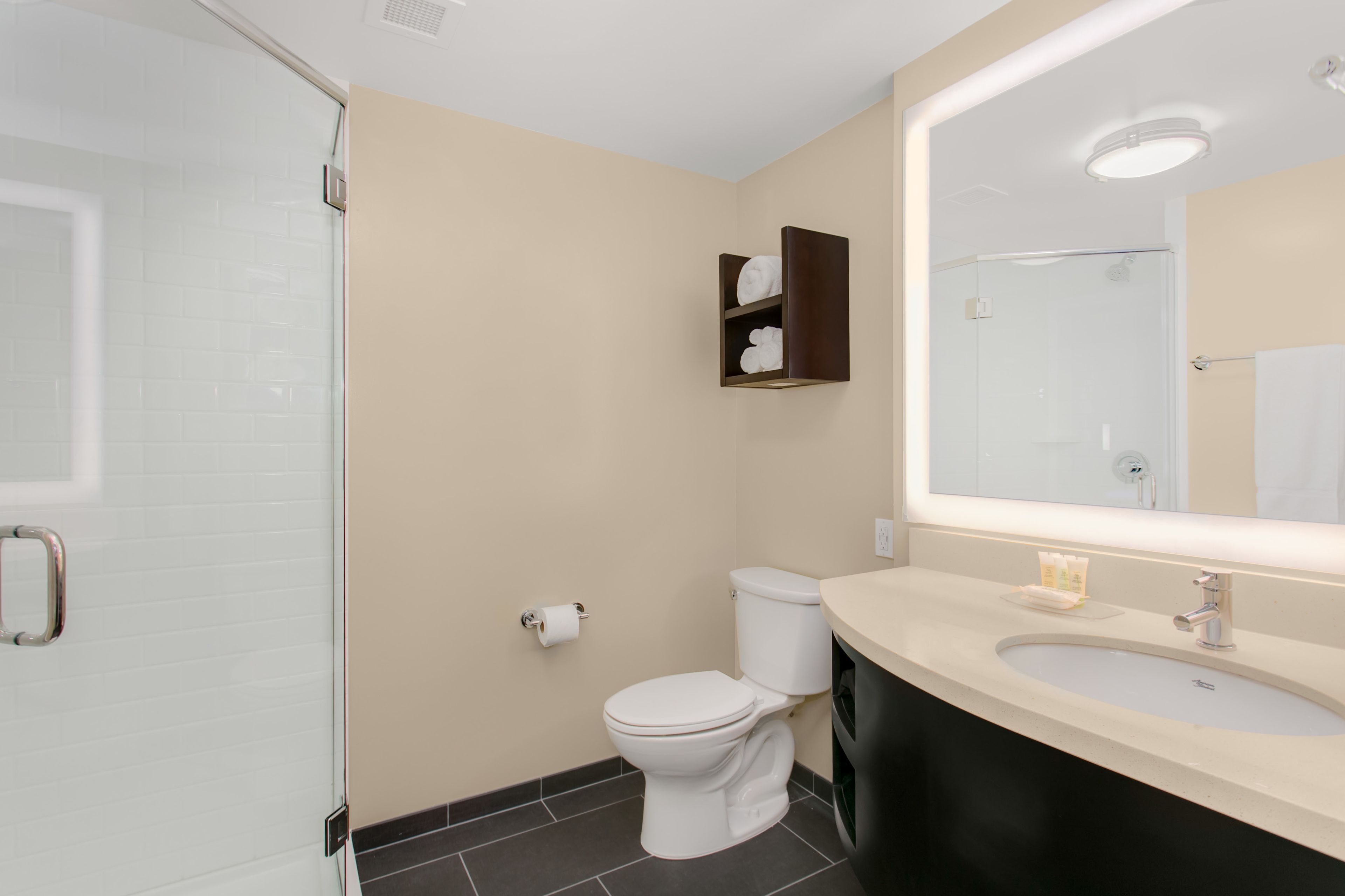 hydromassage showerhead, designer toiletries, hair dryer, towels