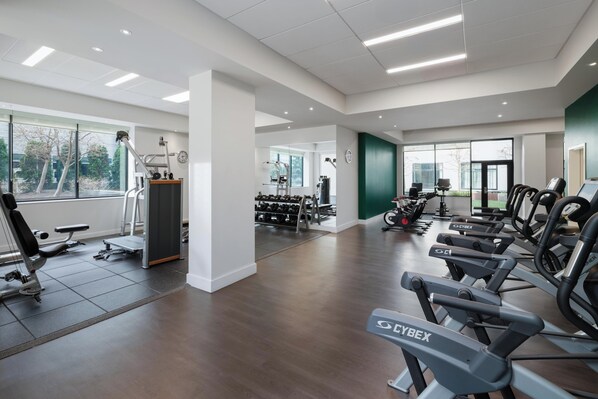 A modern gym with cardio equipment, weight machines, and dumbbells. - Staybridge Suites Seattle Downtown - Lake Union by IHG (Seattle)