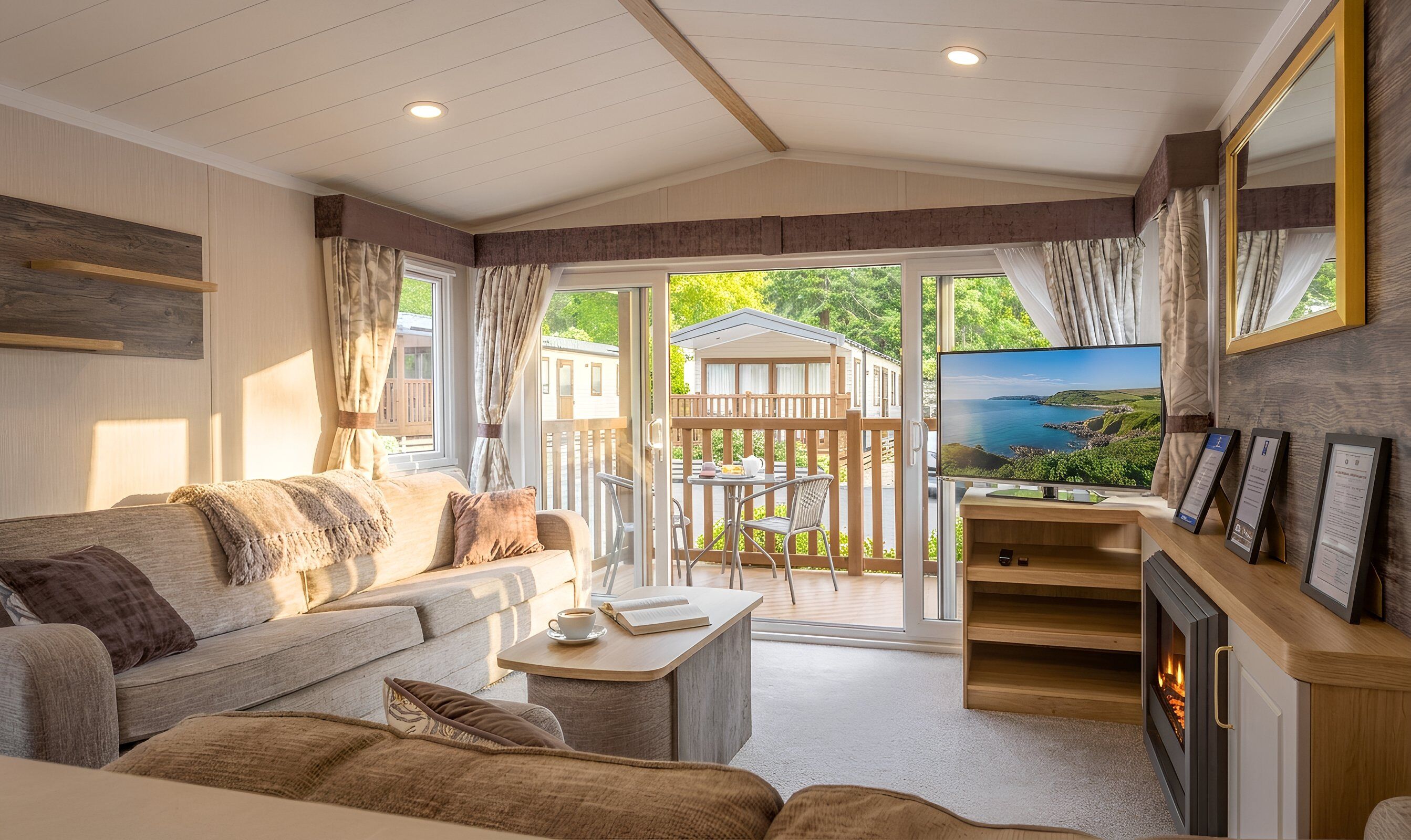 A cozy living room with a sofa, a coffee table, a fireplace, and a television.