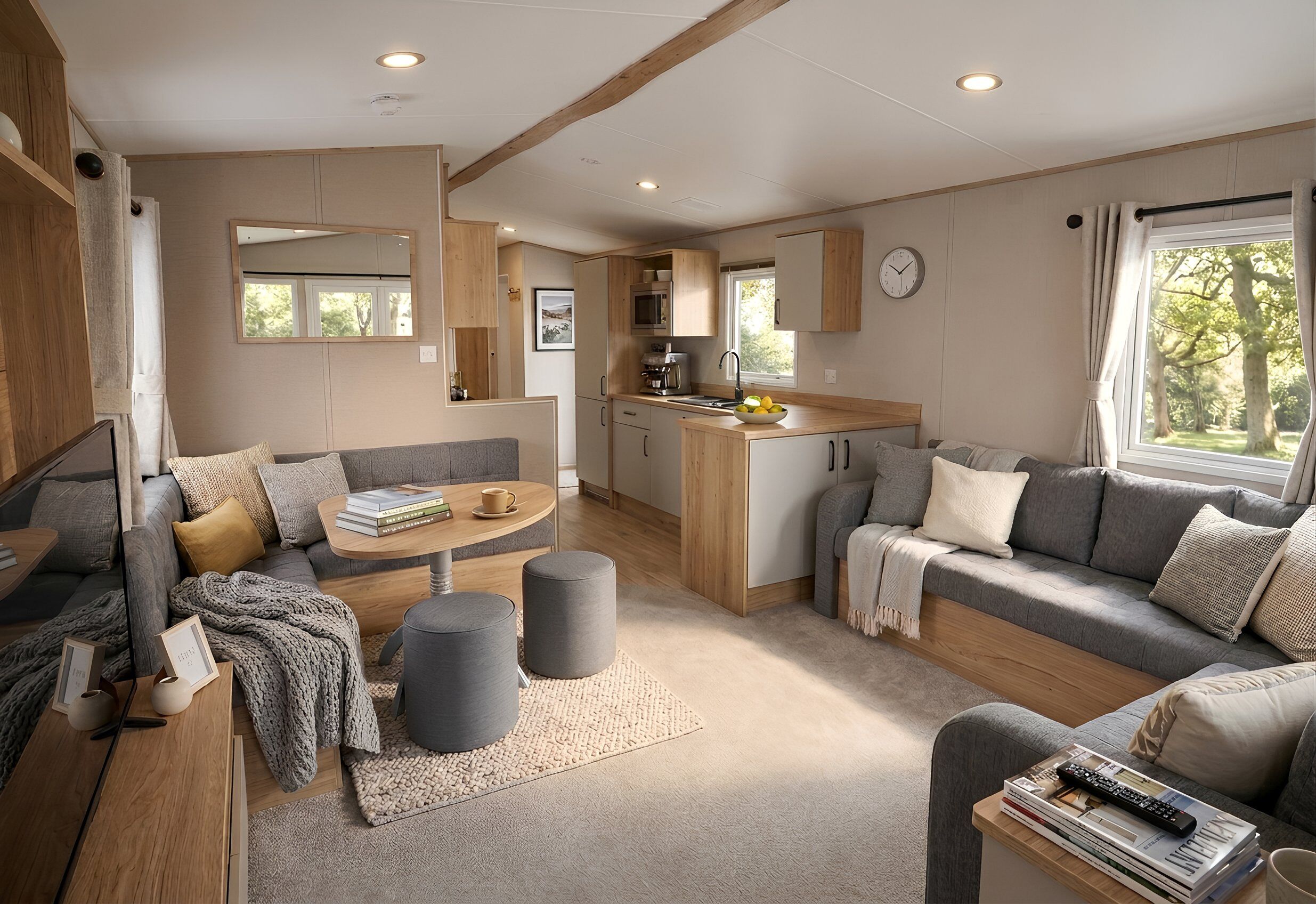 A compact living space with a kitchenette, seating area, and a window providing natural light.