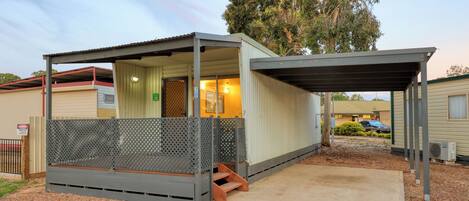 Un petit motel d’un seul étage, doté d’une véranda et d’un espace extérieur clôturé.