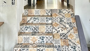 A staircase with patterned tiles leading to a room. - Hotel Boutique Valverde Santa Elena (Antiguo Cuscatlán)