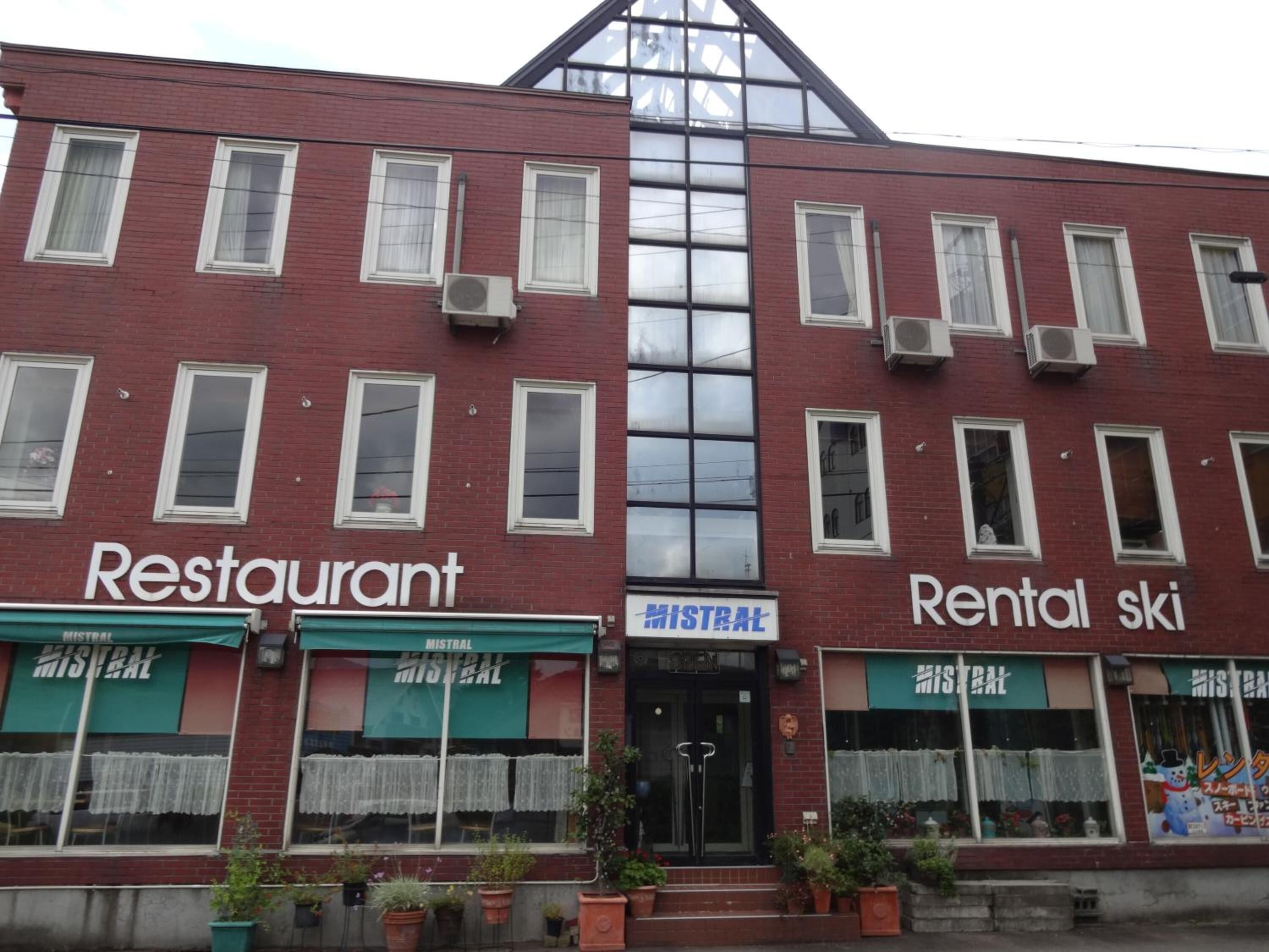 A two-story building with a restaurant and a rental ski facility.