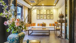 Una sala de estar moderna con un conjunto de sofá, una mesa de centro y un jarrón decorativo con flores.