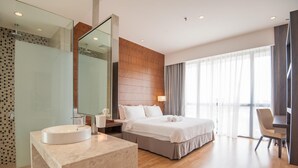 A modern hotel room with a large bed, a round bathroom sink, a mirror, and a view of the outdoors through large windows. - D'Majestic Place by Widebed (Kuala Lumpur)