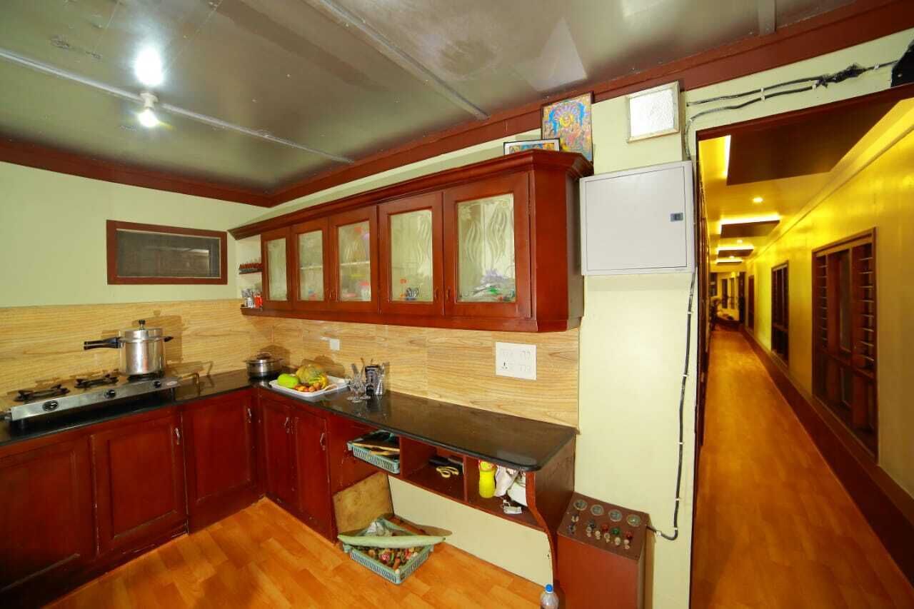A kitchen with wooden cabinets, a stove, and a refrigerator.
