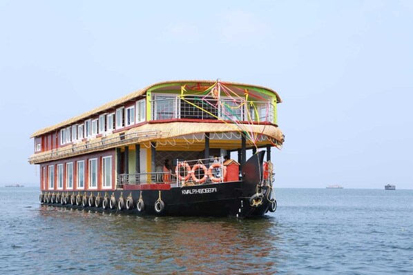 A double-decked boat with lifebuoys and a clear view of the water.