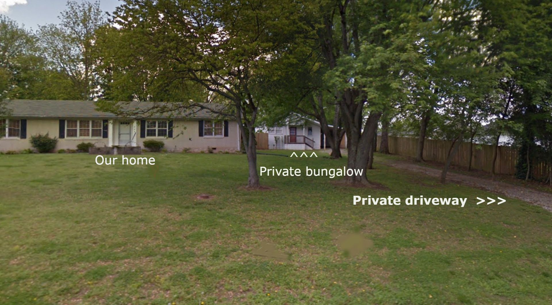 A private bungalow with a grassy yard and a private driveway.