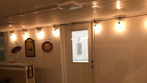 A room with a wooden ceiling, a white door with a window, and a small mat on the floor. - 1 Block to the Beach, Fully Fenced in Backyard, Golf Cart Included (Myrtle Beach)