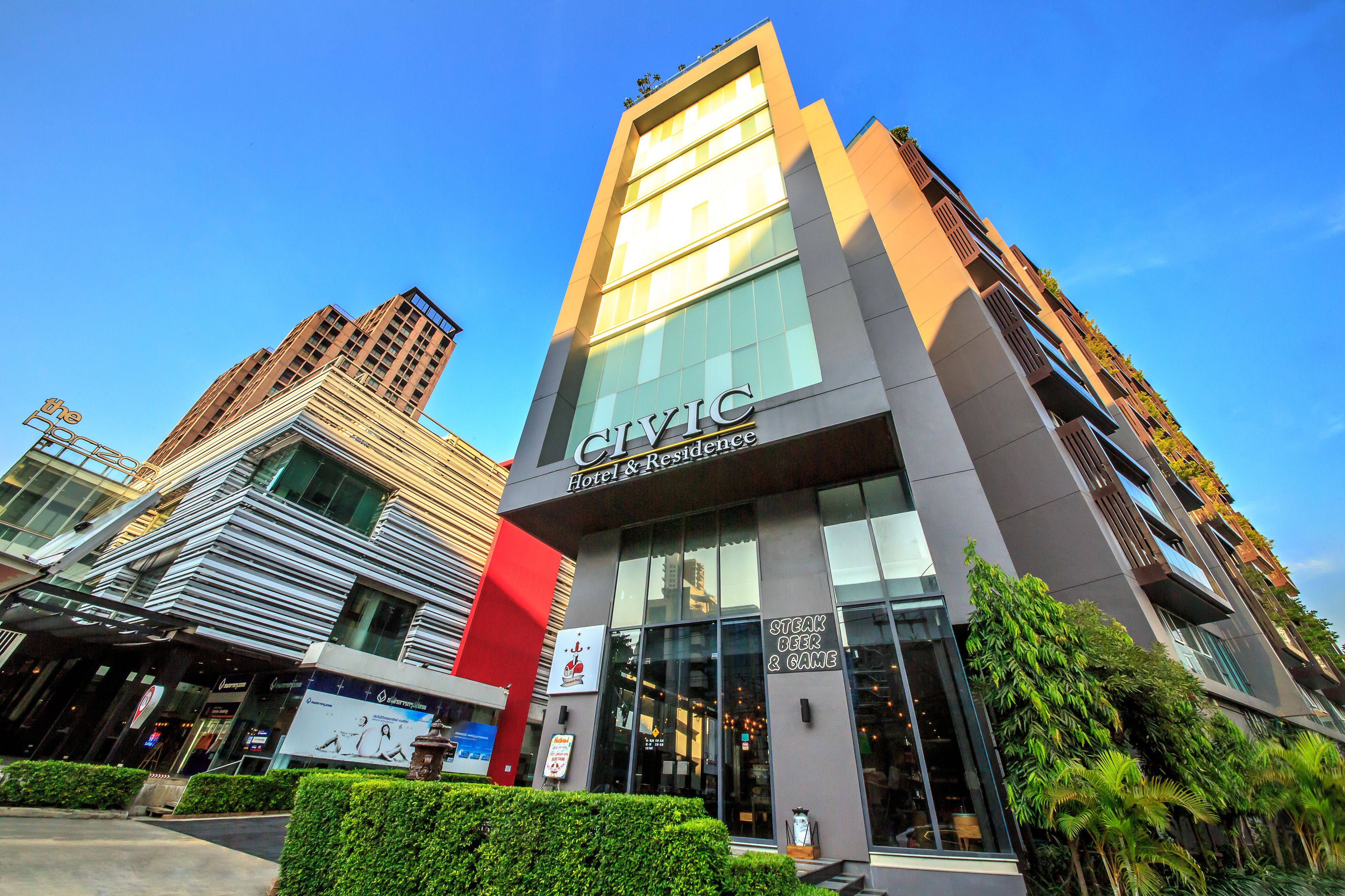 A modern hotel with a prominent sign reading "CIVIC Hotel & Residence."