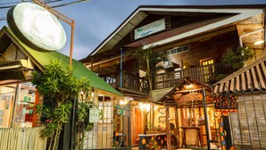 A traditional wooden building with a balcony, a signboard, and a push sign. - Lala Panzi (Puerto Princesa)