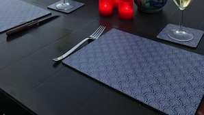 A table set for two with wine glasses, a bowl of food, a vase of flowers, and candles on a balcony overlooking a body of water. - El Capistrano, Nerja 2 bedroom apartment with south facing private garden (Nerja (Malaga))