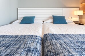 A double bed with two pillows, a headboard, and a nightstand with a lamp. - Amazing, 5 stars! Beautiful 27m2 terrace beachfront condo! WIFI 150MBS - ONLY FAMILIES (Playa de Gandía)