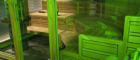 A room with a green-tinted view, wooden furniture, and a visible window.