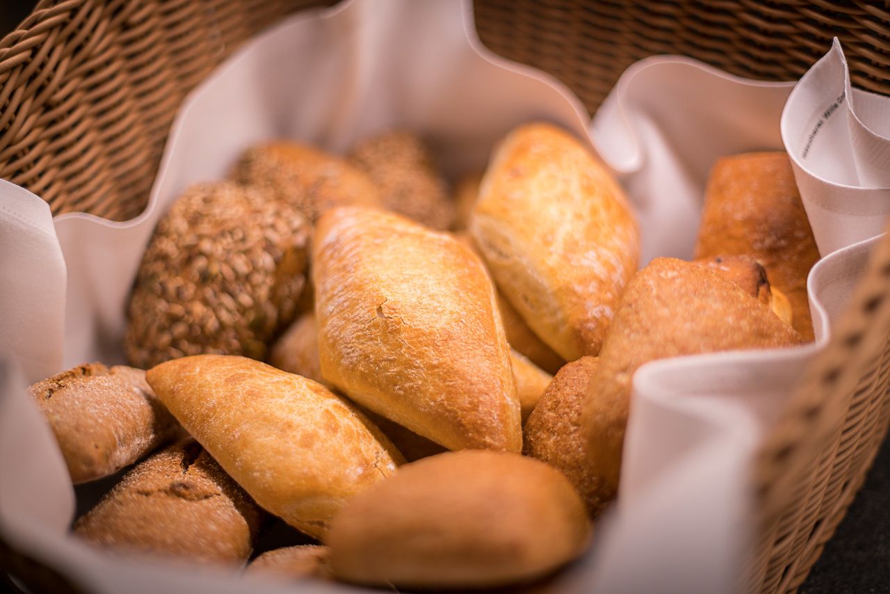 A basket filled with various types of bread.