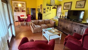 A living room with a sofa, armchairs, a coffee table, and a television. - The colors of Chianti  (Mercatale In Val di Pesa)