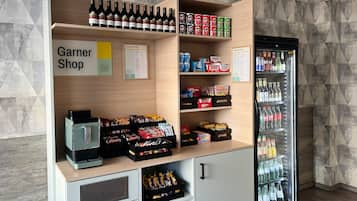 A snack and drink station with a variety of snacks, drinks, and a coffee machine.