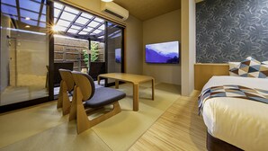 A hotel room with a bed, a TV, a table, and a chair. - Takachiho Hanareno-yado Kamigakure (Takachiho)
