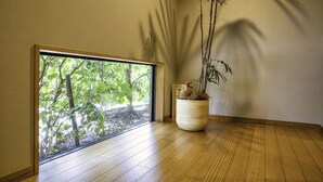 A room with a large window, wooden flooring, and a potted plant. - Takachiho Hanareno-yado Kamigakure (Takachiho)