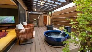 A wooden deck with a hot tub, seating area, and a television screen. - Takachiho Hanareno-yado Kamigakure (Takachiho)