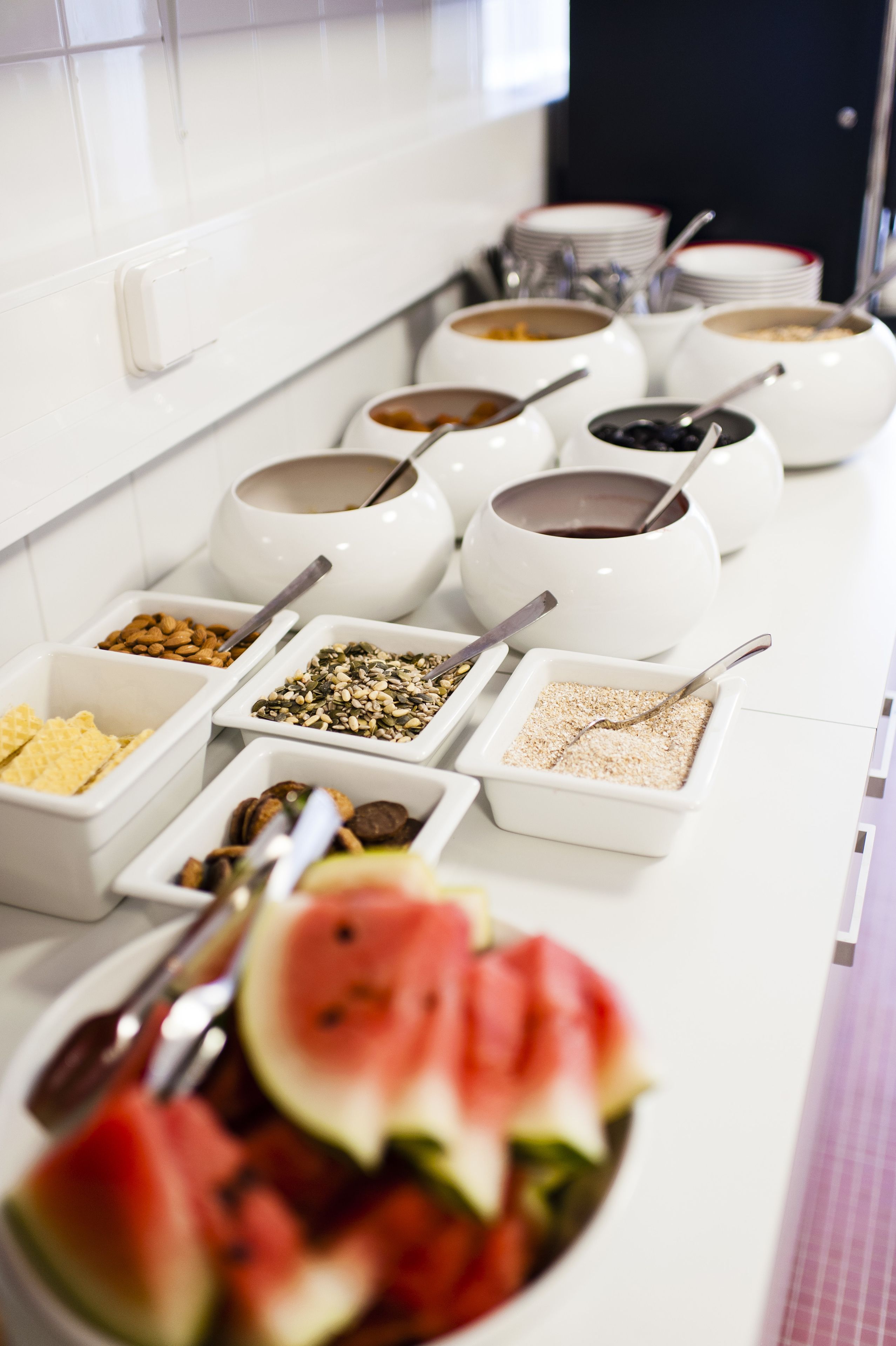 A buffet with various food items and bowls.