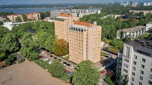 A high-rise building with multiple floors, surrounded by greenery and a parking area. - Töölö Towers (Helsinki)