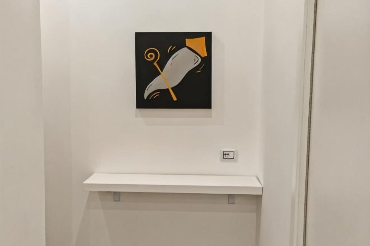 A wall-mounted artwork with abstract shapes and lines.