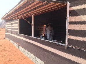 A building with a striped exterior and a window open.