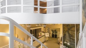 A multi-level interior with a staircase connecting floors, a kitchen area, and a dining space. - Hotel Wodnik (Wroclaw)