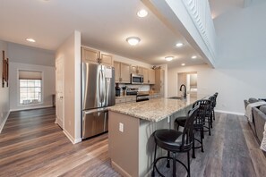 Enjoy casual dining at the kitchen bar with ample counter space and appliances.