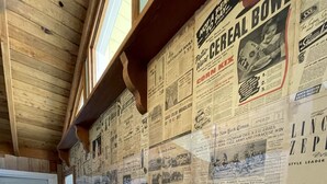 A hallway with a wooden ceiling and walls covered in old newspapers. - Beach View, Private Plunge Pool, Charming 1938 Bungalow Madeira Beach Gulf-Blvd (Madeira Beach)