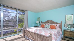 A bedroom with a large window, a wooden bed, two bedside tables, and a nightstand. - Kingston Arms Paradise!
 Saint  Armands Circle & Lido Beach!  Fully Equipped! (Sarasota)
