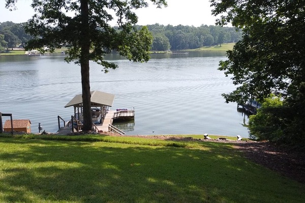 Covered dock with built in bench, swing and swim platform.