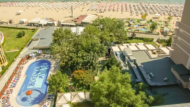 A resort with a large pool area, a beach, and a view of the ocean. - Hotel Shipka Beach (Sunny Beach)