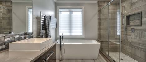 Deep soaking tub, rainfall showerhead, slippers, towels