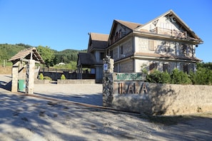 A two-story building with a stone facade and a tiled roof, labeled "Agriturismo".