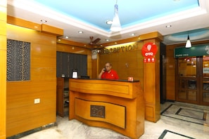 A reception desk with a sign that reads "RECEPTION" and "OYO". - OYO 5208 The Park View Inn (Chennai)